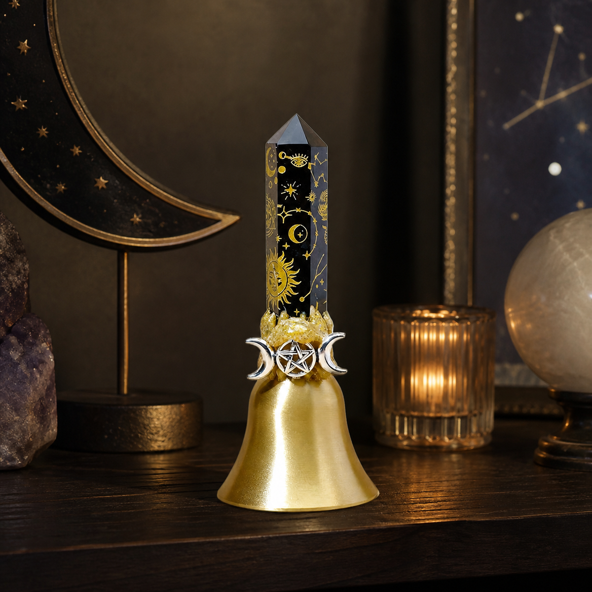 Decorative pillar hand bell standing on a dark wood shelf beside books and small objects